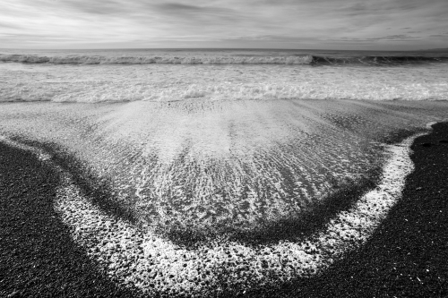 Ocean beach with black gravel north of Christchurch