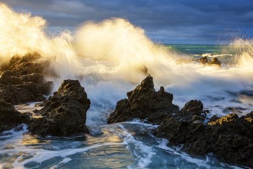 Rocky shore north of Kaikora at sunrise with dramatic storm clouds